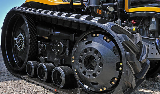 Close-up of a tractor showcasing a large tire, emphasizing the importance of selecting the right track type for heavy machinery.
